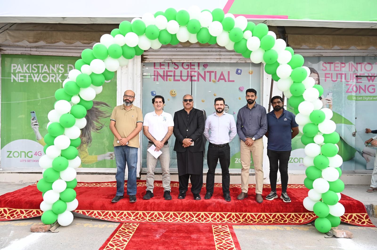 Barkat Traders team at a ZONG store opening with a balloon arch